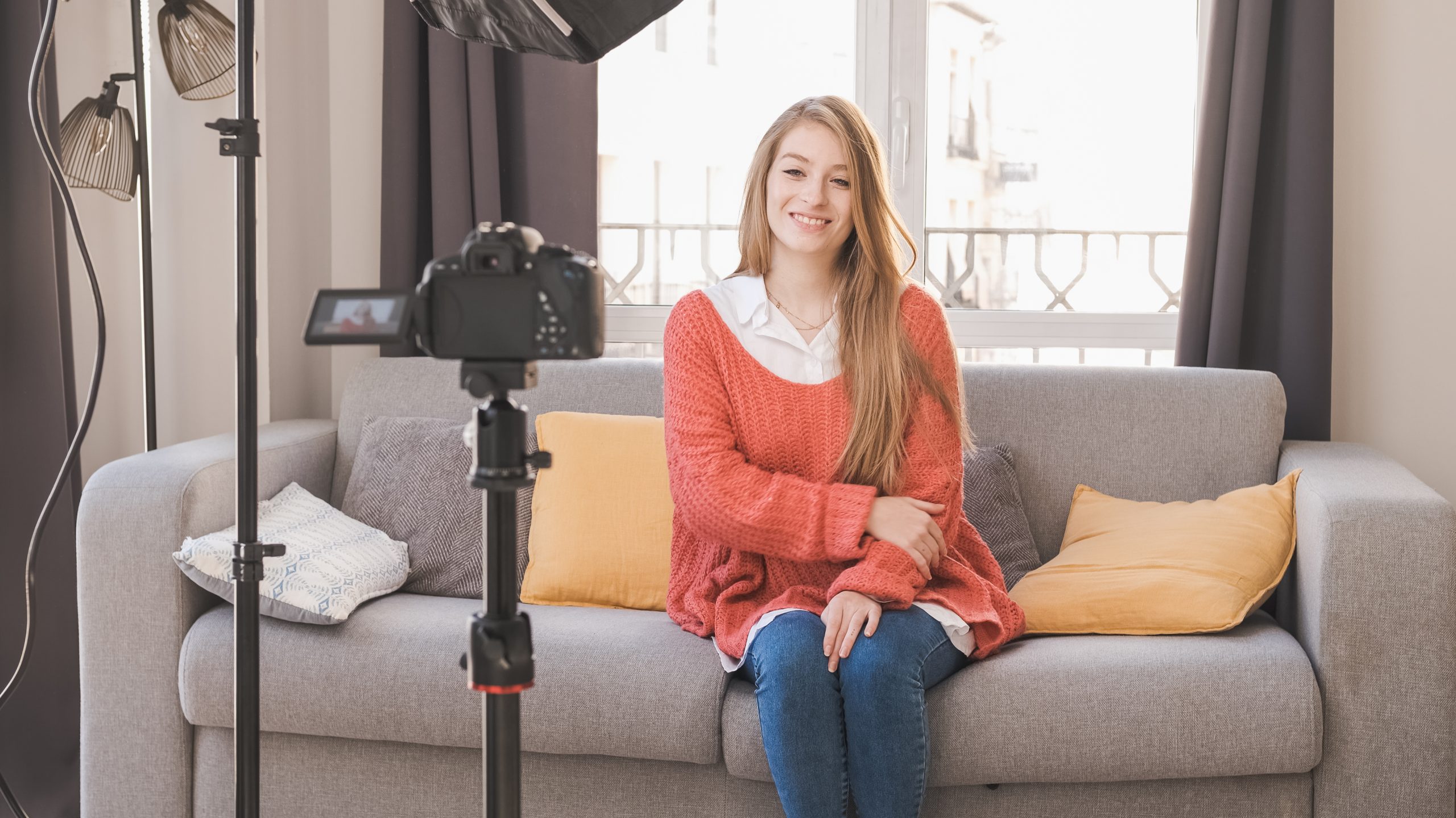 Young youtuber or blogger woman creating content for social media while making a video at her home.